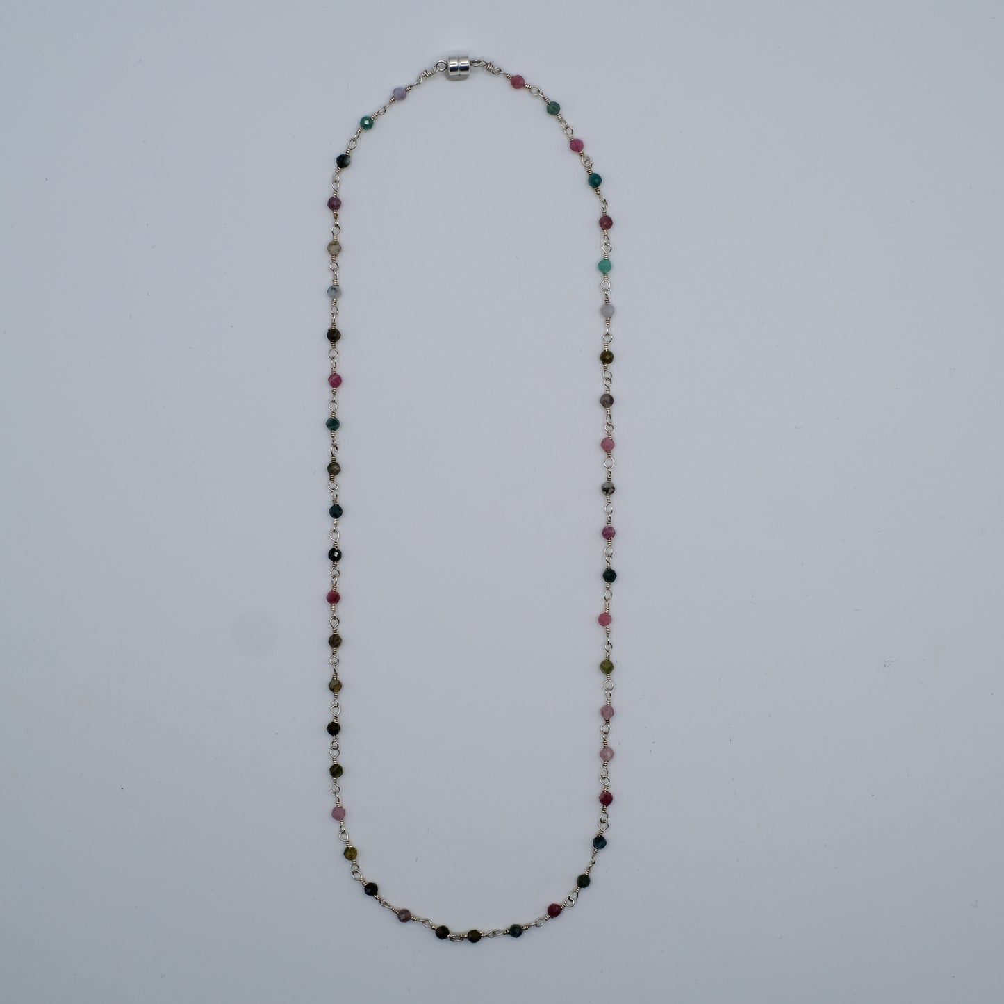Multicolored beaded necklace on a light gray background